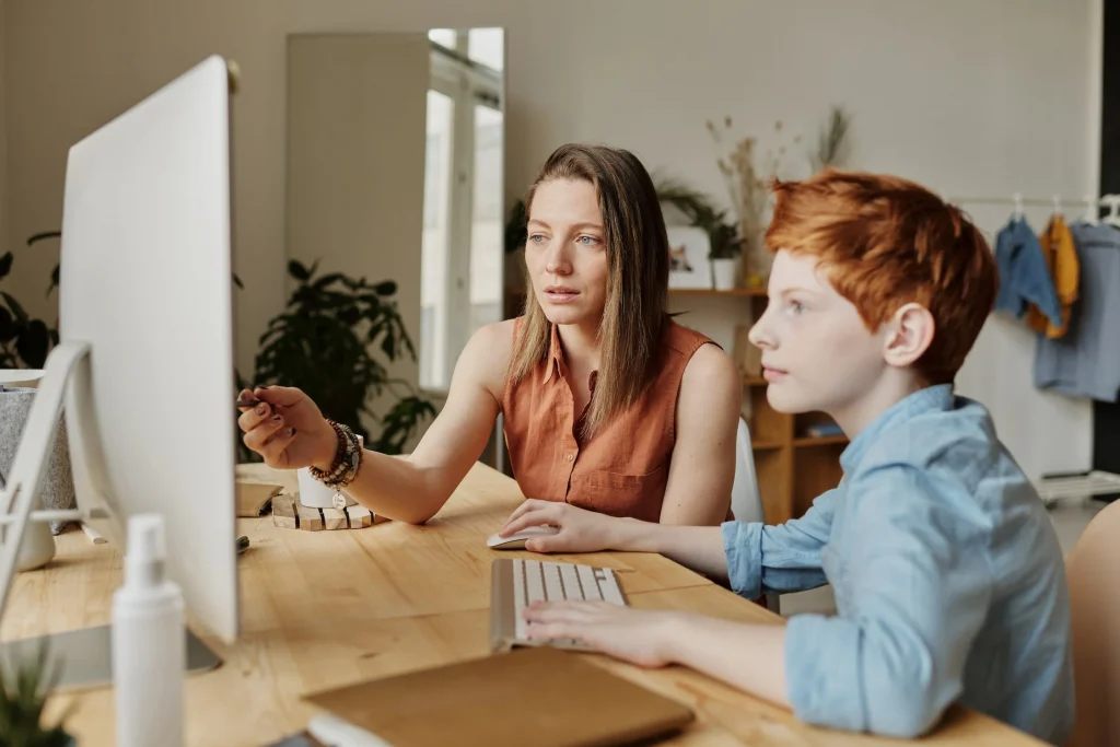 Stock photo from pexels by Julia M Cameron of a woman and child on a computer