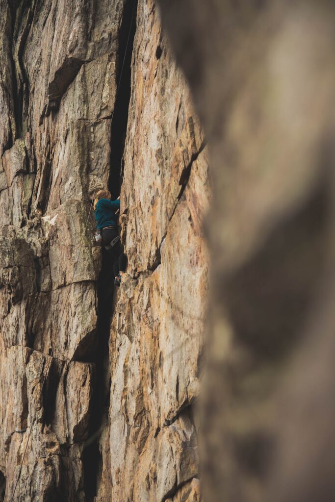 Stock photo from pexels by andrew shelley of a person rock climbing