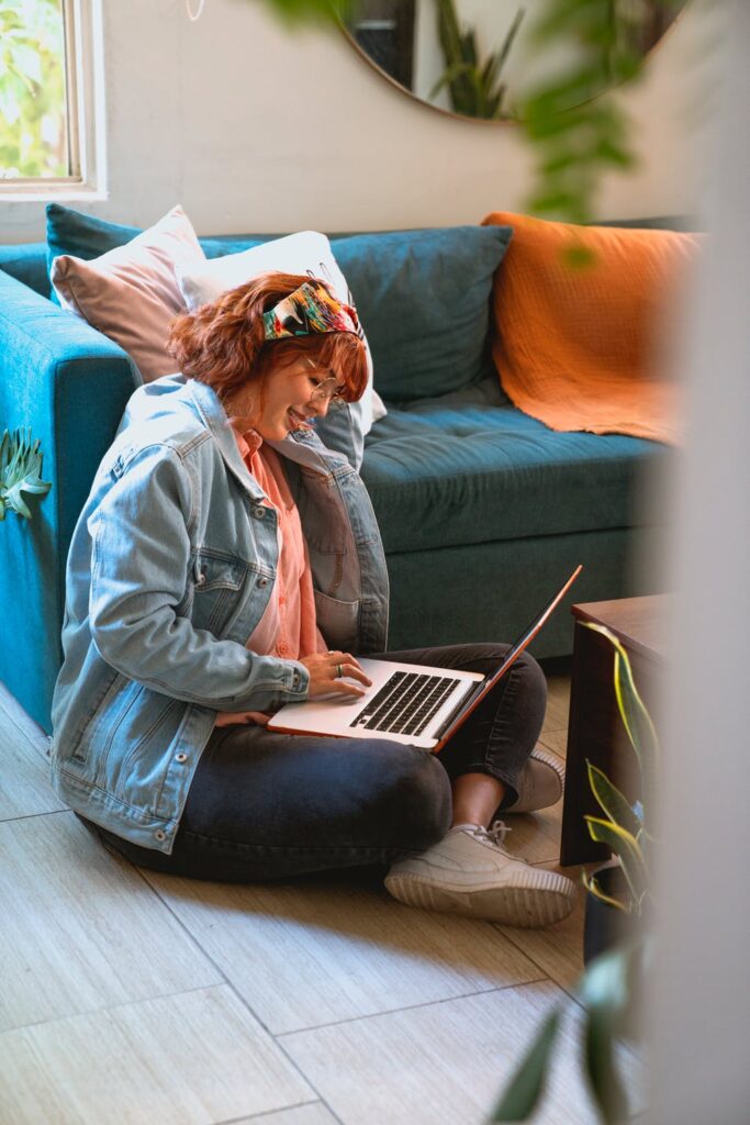 Stock Photo from Pexels by Los Muertos Crew of a Woman sitting on the floor using a laptop