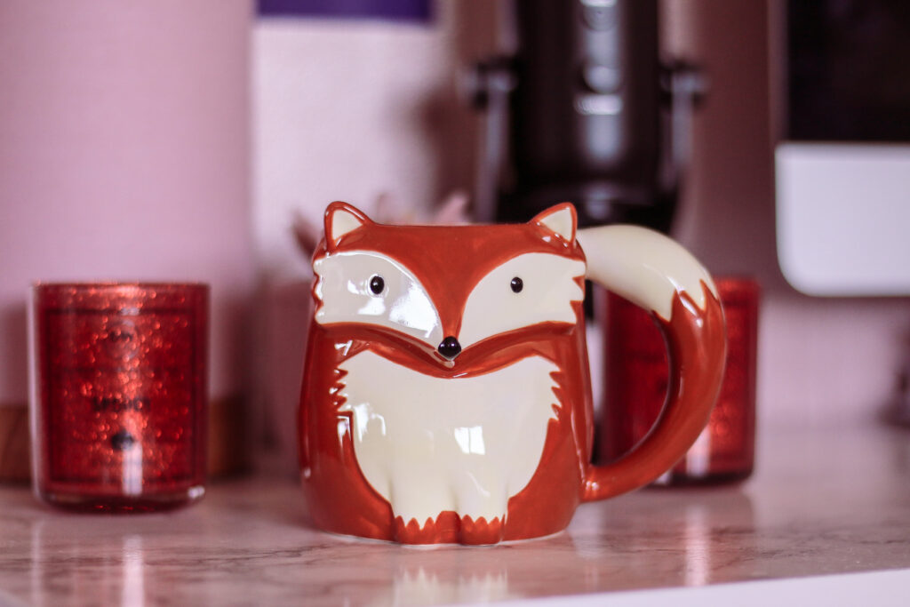 close up photo of a fox mug on a desk