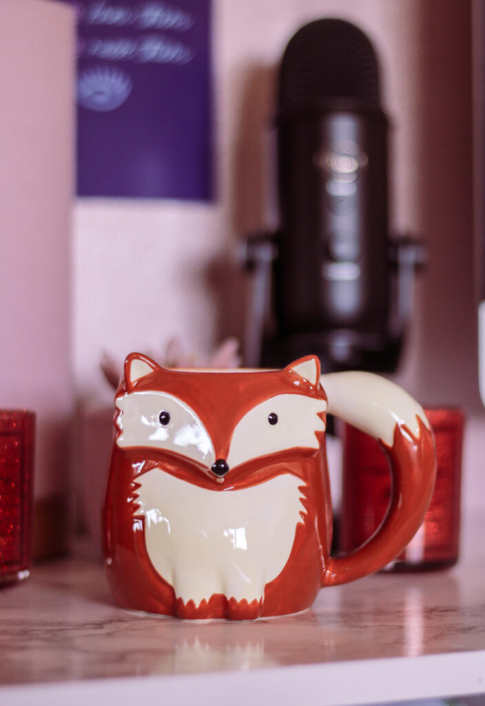 close up photo of a fox mug on a desk