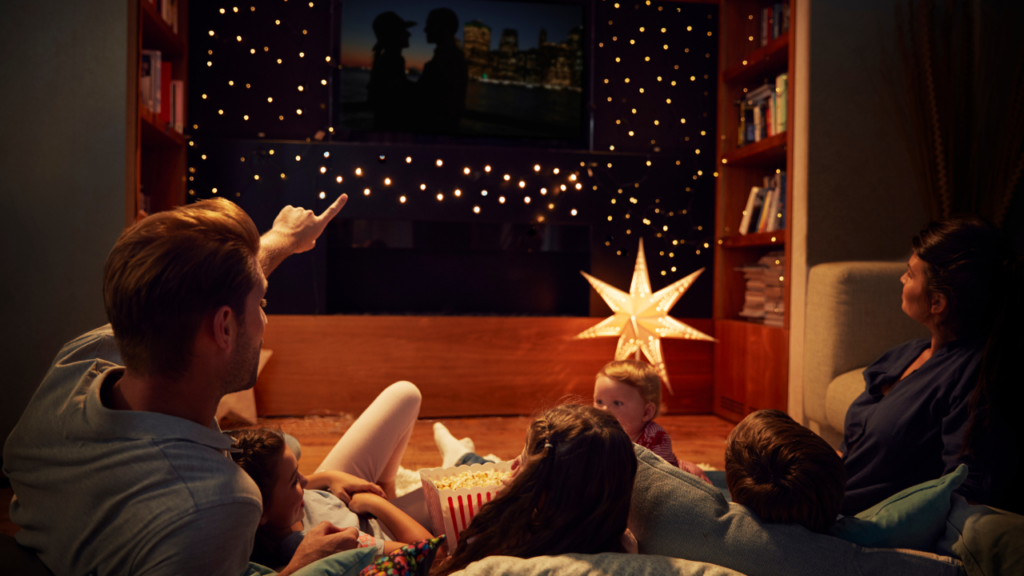 Stock photo from Canva by monkey business images of a Family watching a Christmas movie