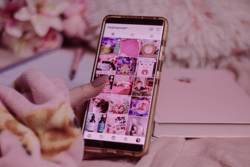 Close up photo of Jordanne holding a smart phone with Instagram on the screen