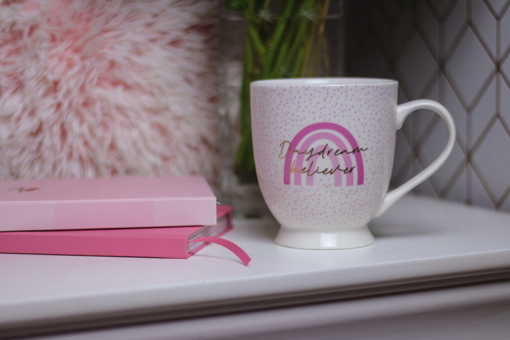 Close up photo of a white mug on a white set of drawers