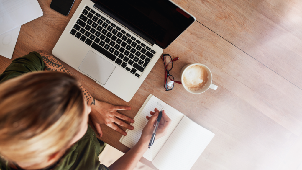 Stock photo from Canva by Jacob Lund of a woman writing in a notebook