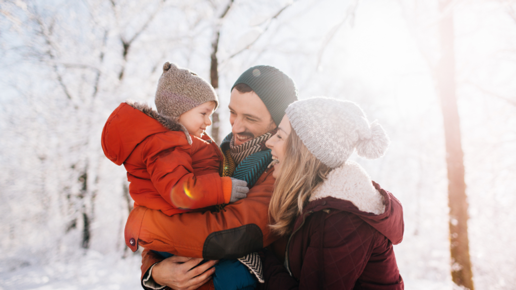 Stock photo on Canva from Getty Images of a family playing in the snow