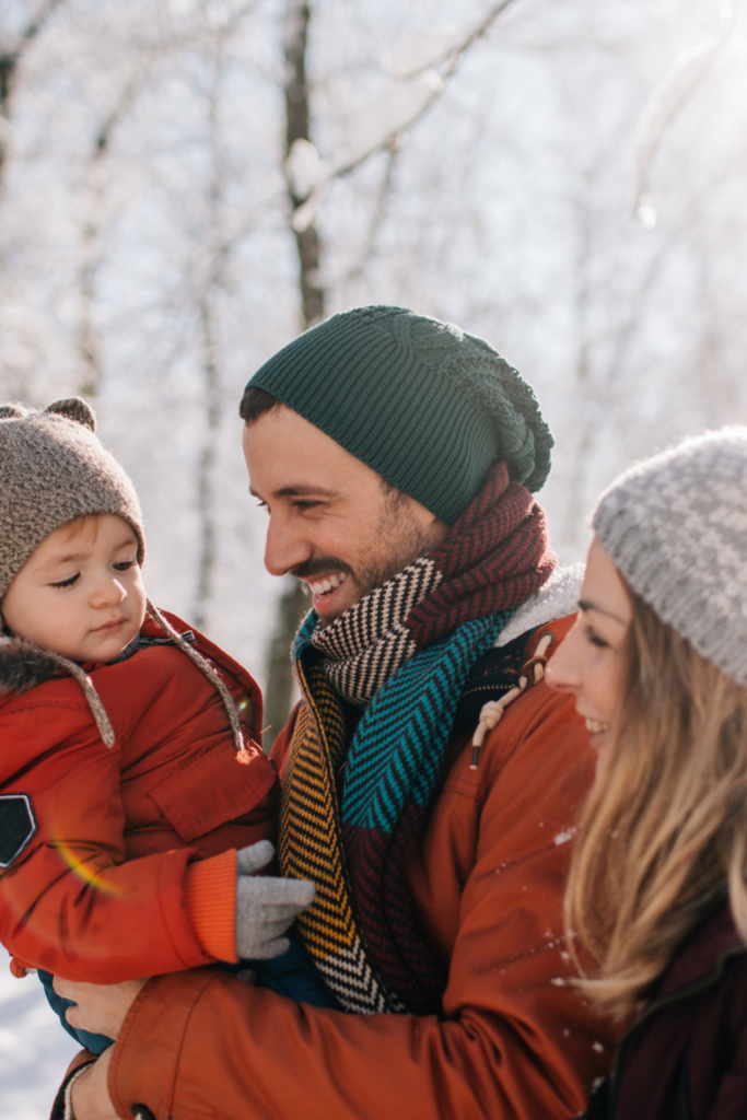 Stock photo on Canva from Getty Images of a family playing in the snow