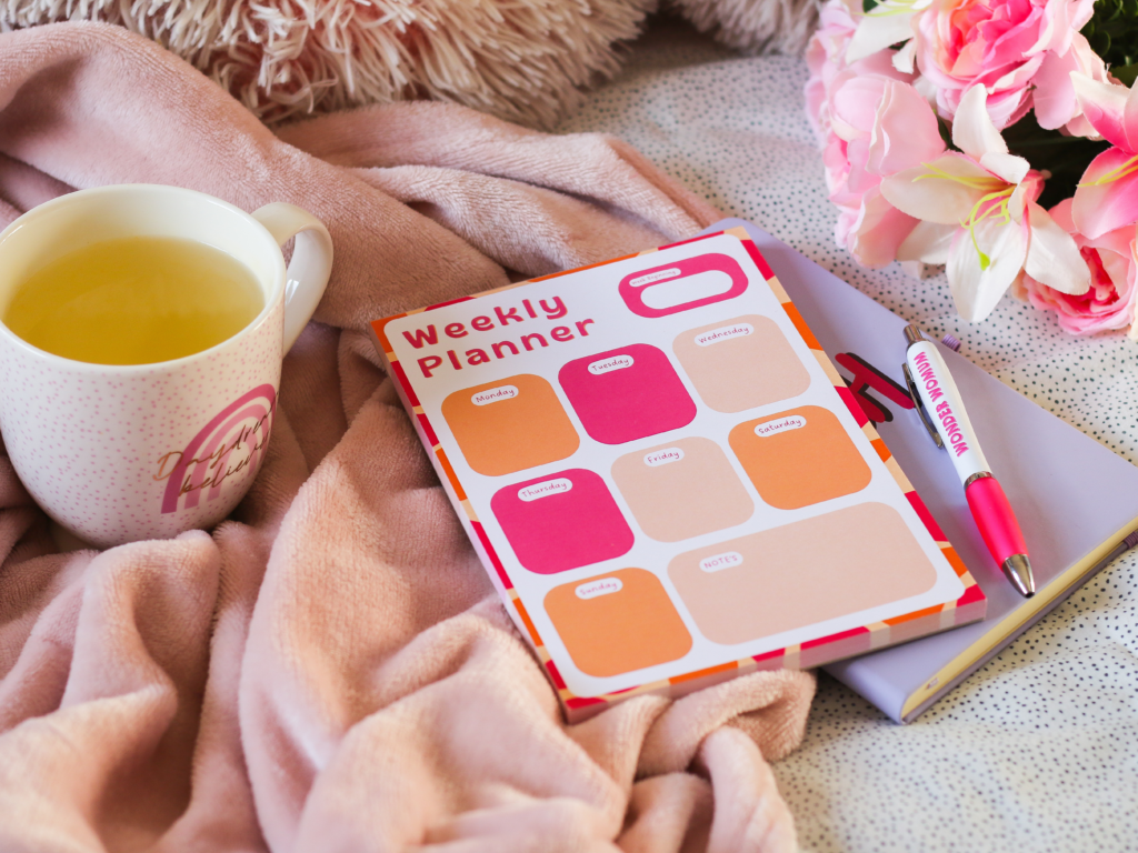 Photo of a bright pink and orange weekly planner notepad by jordanneleecreative.etsy.com