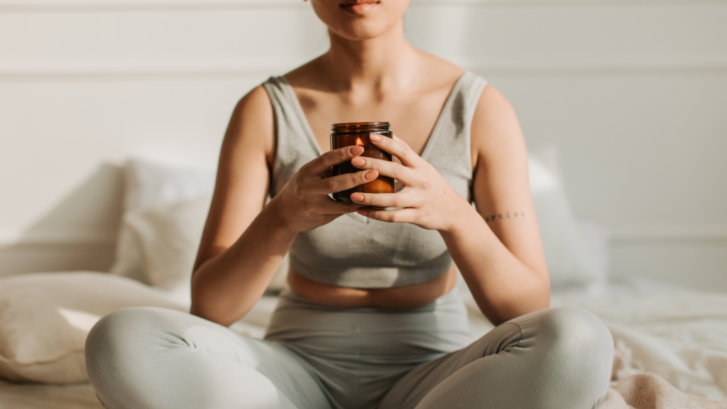 Stock photo from Vlada Karpovich at Baseimage of a woman wearing a sage green workout two piece meditating on a floor