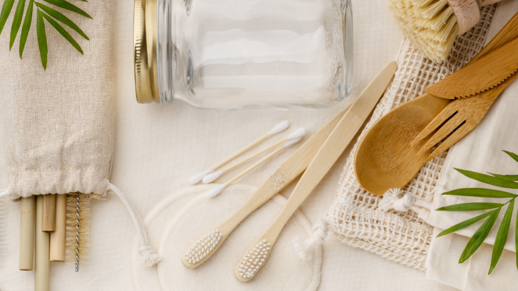 Stock photo from Canva by Natalia Klenova of Neutral canvas bags, metal straws, bamboo cutlery and a glass mason jar