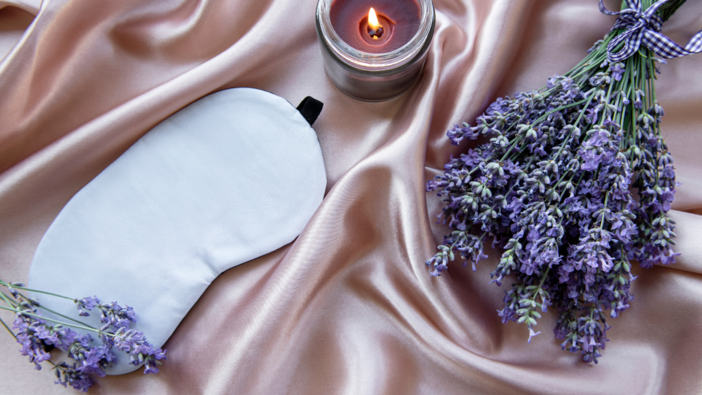 Stock photo from Canva by Olena Rudo of a sleep mask on a silk pink sheet