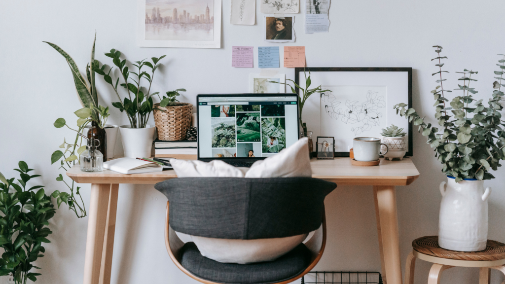 Stock photo from pexels by Teona Swift of a Comfortable workplace with laptop and green plants at table