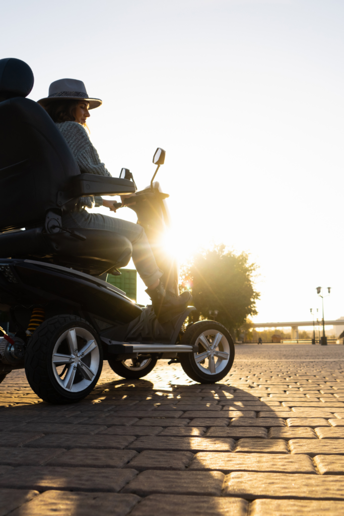 Stock photo from Canva by Scharfsinn86 at Getty Images of a woman sitting on a mobility scooter on a pier