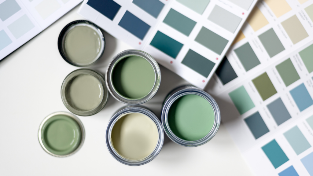 Stock photo from Canva by Annastories of 6 tins of green paint