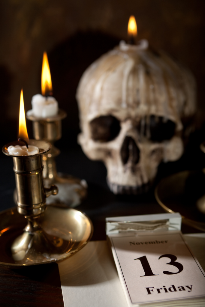 Stock photo from Canva by Anyka of a skull candle holder and a desk calendar displaying Friday 13th
