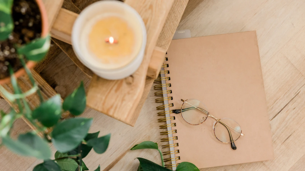 A stock photo from Canva of a table with a burning candle