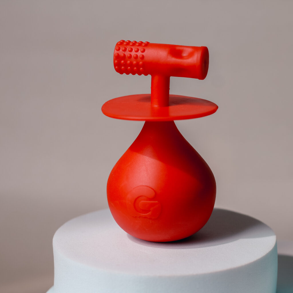 Close up photo of the red Molar Mallet Teething Toy from Gummee, taken by Ofaglasgowgirl