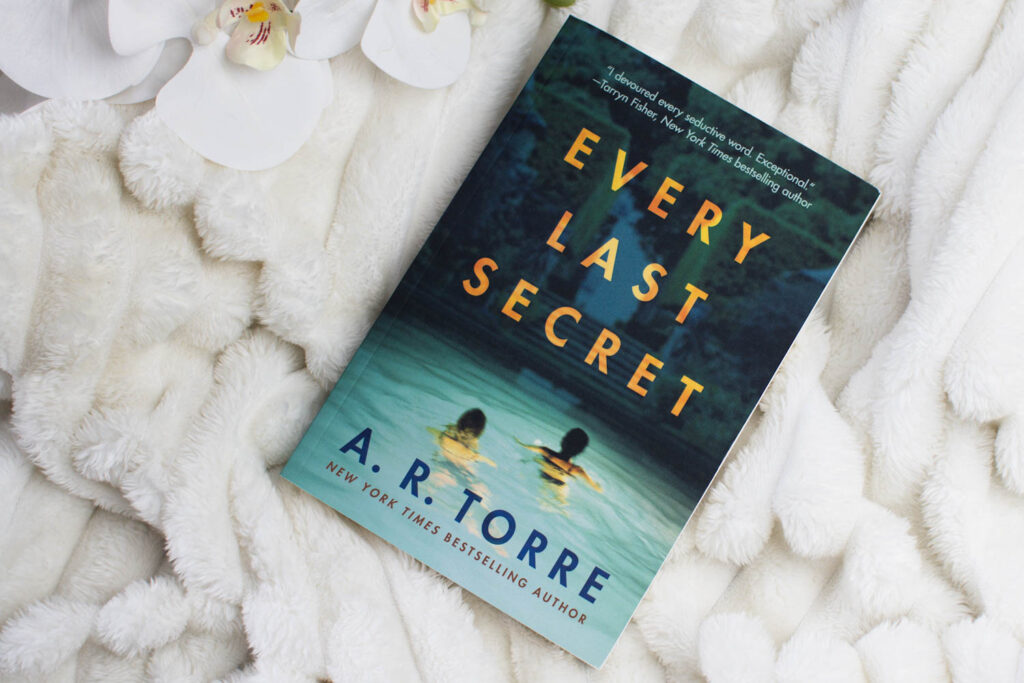 Bird's-eye view photo of Every Last Secret Book on a white throw, taken by Jordanne / Ofaglasgowgirl